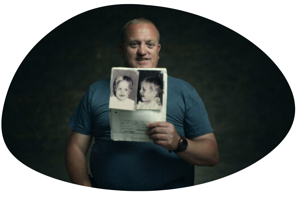 A man holding a photo from the documentary Ghosthunter.